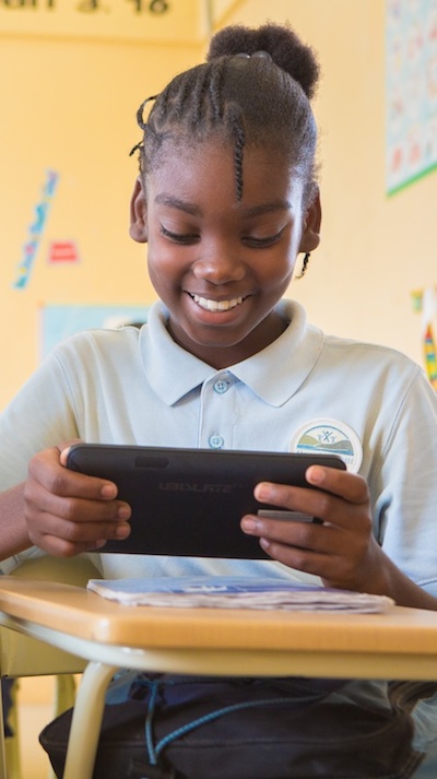 Respire Haiti student with tablet