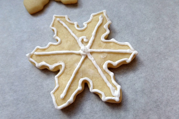 Icing a snowflake cookie