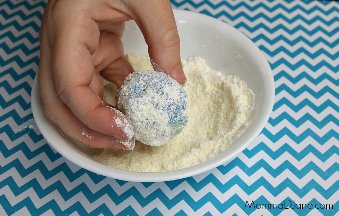 roll snowball cookies in powder sugar