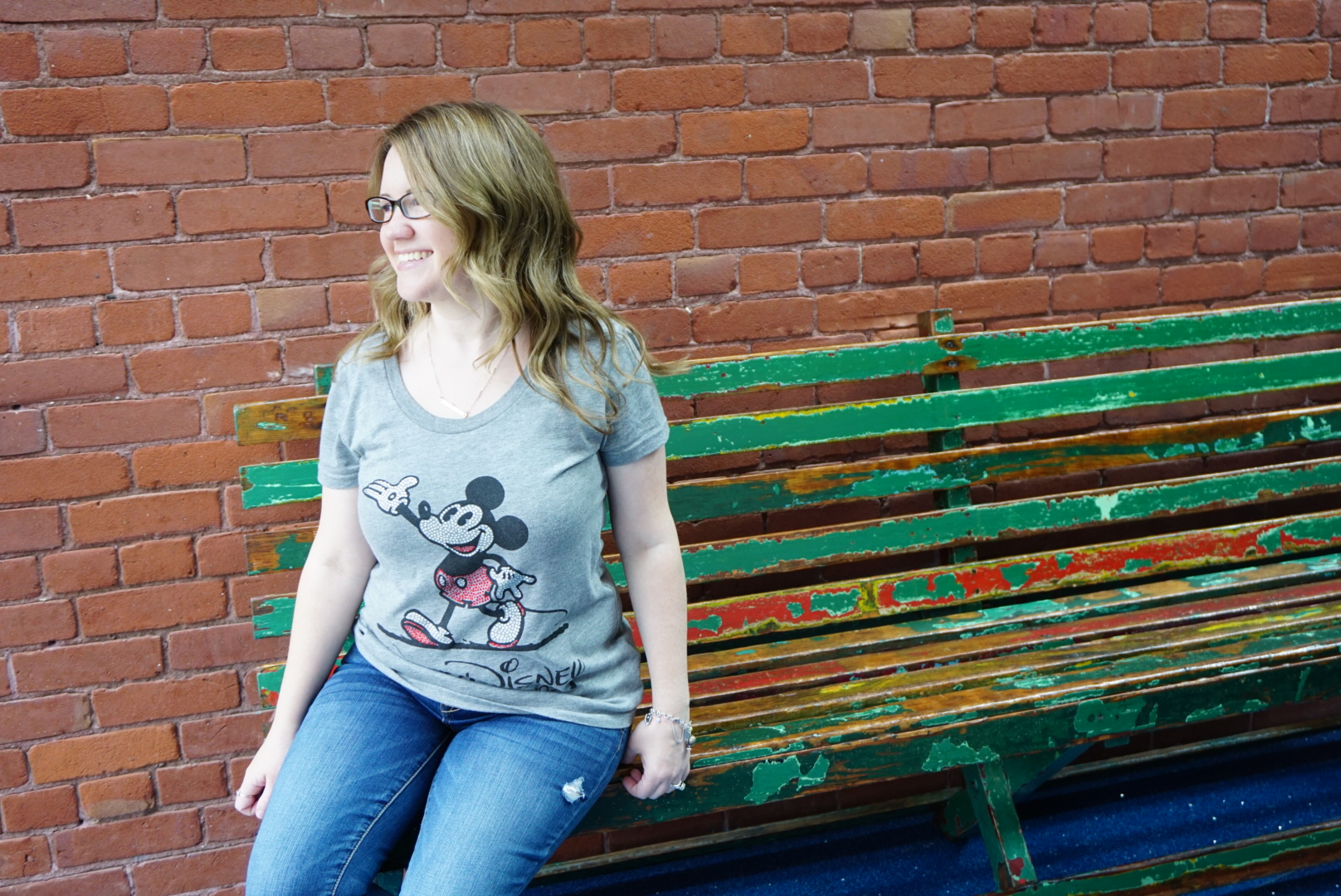 sitting on Walt Disney's bench from Griffith Park in museum