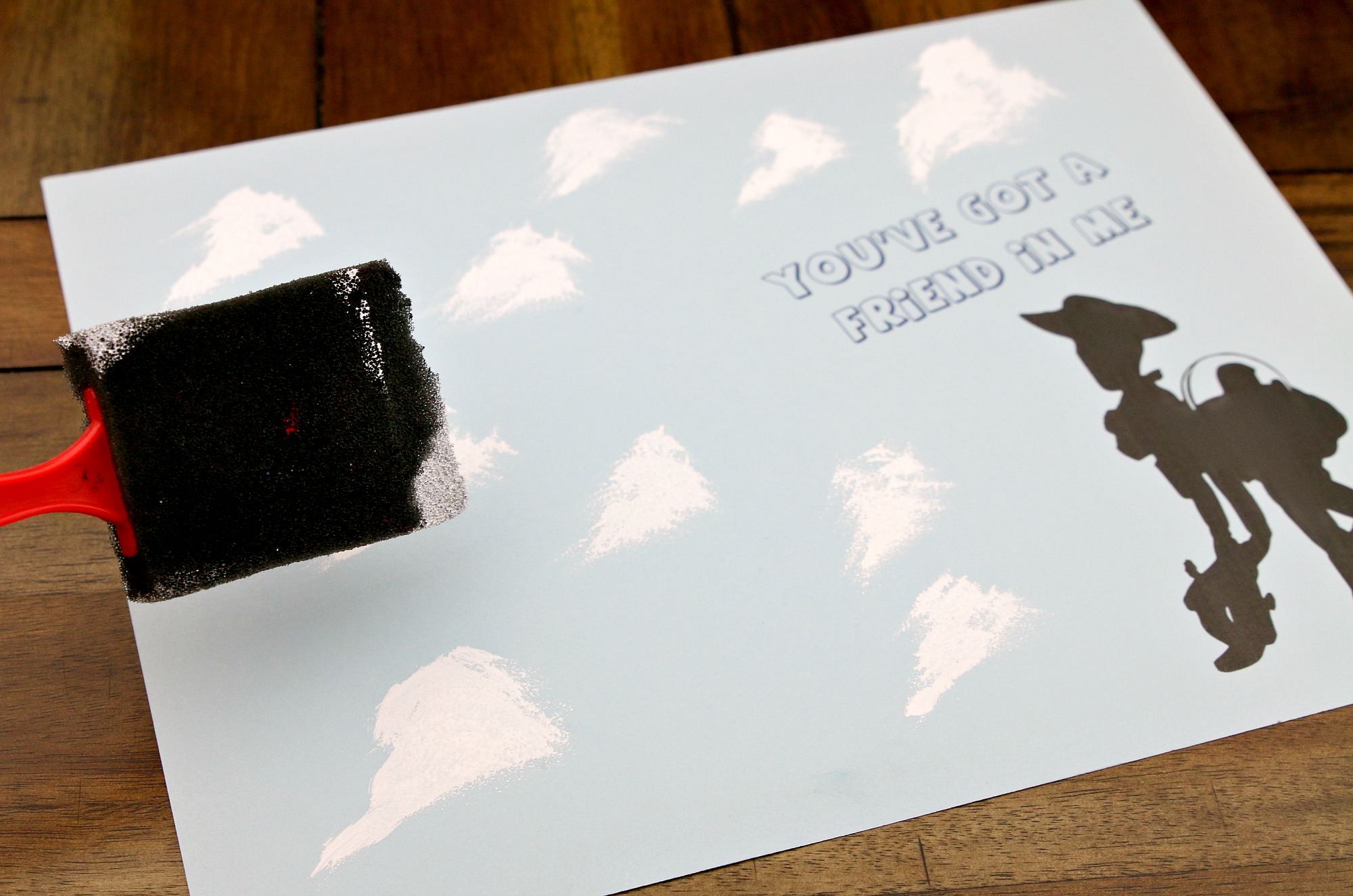 paint white clouds with sponge brush