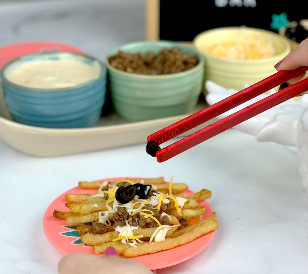 adding olives to French fries
